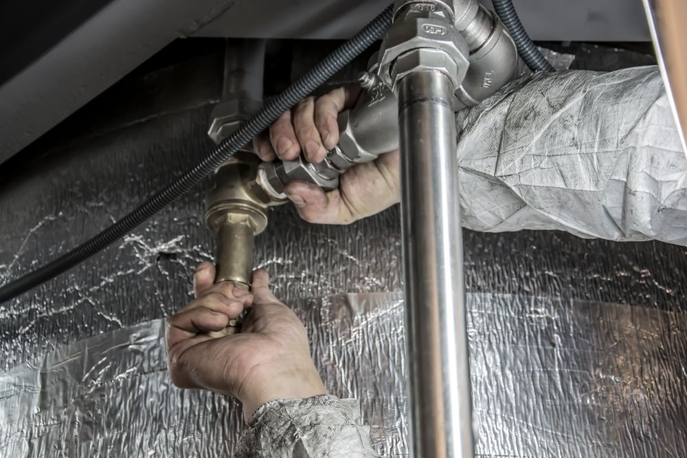 HNR plumber installing pipe fittings