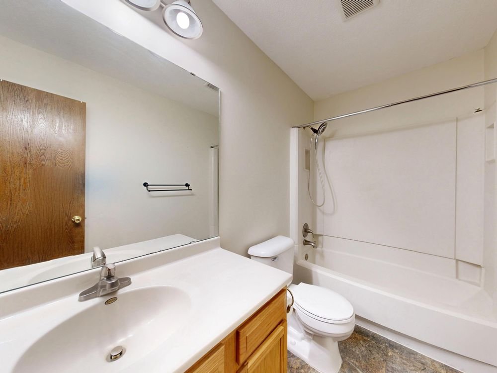 Modern bathroom renovation with white fixtures
